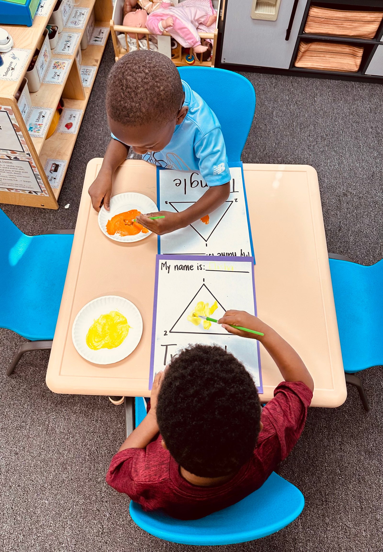 Child doing an art activity at a classroom table